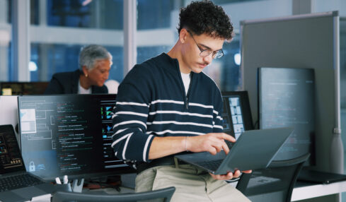Man, programmer and office with laptop for coding, software development or app design. Male person, coder or developer with computer or technology for cybersecurity, web or IT services at workplace