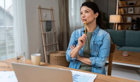 Business woman video call preparation. Young female businessperson prepare herself for online meeting, making notes for internet presentation, thinking and planning for better achievement with client