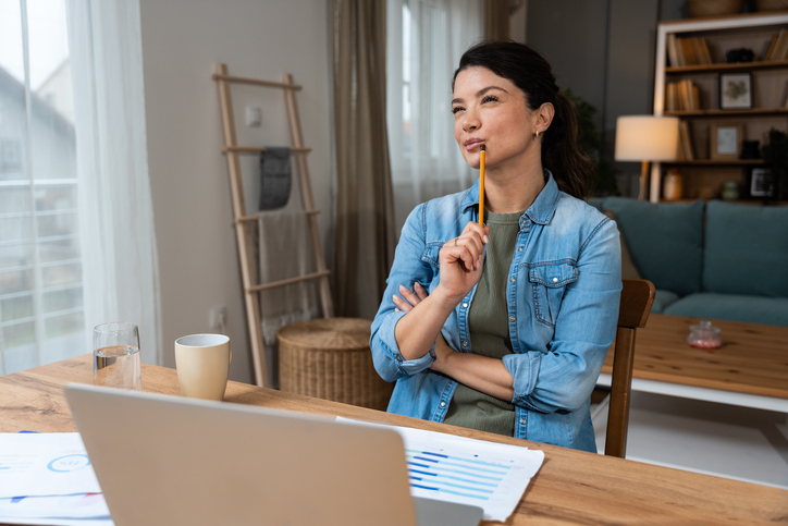 Business woman video call preparation. Young female businessperson prepare herself for online meeting, making notes for internet presentation, thinking and planning for better achievement with client